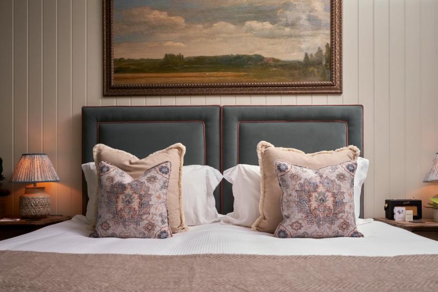 Cotswold Gardens B&B - Wonderful Winchcombe A painting of English countryside hangs above a large bed with decorative cushions